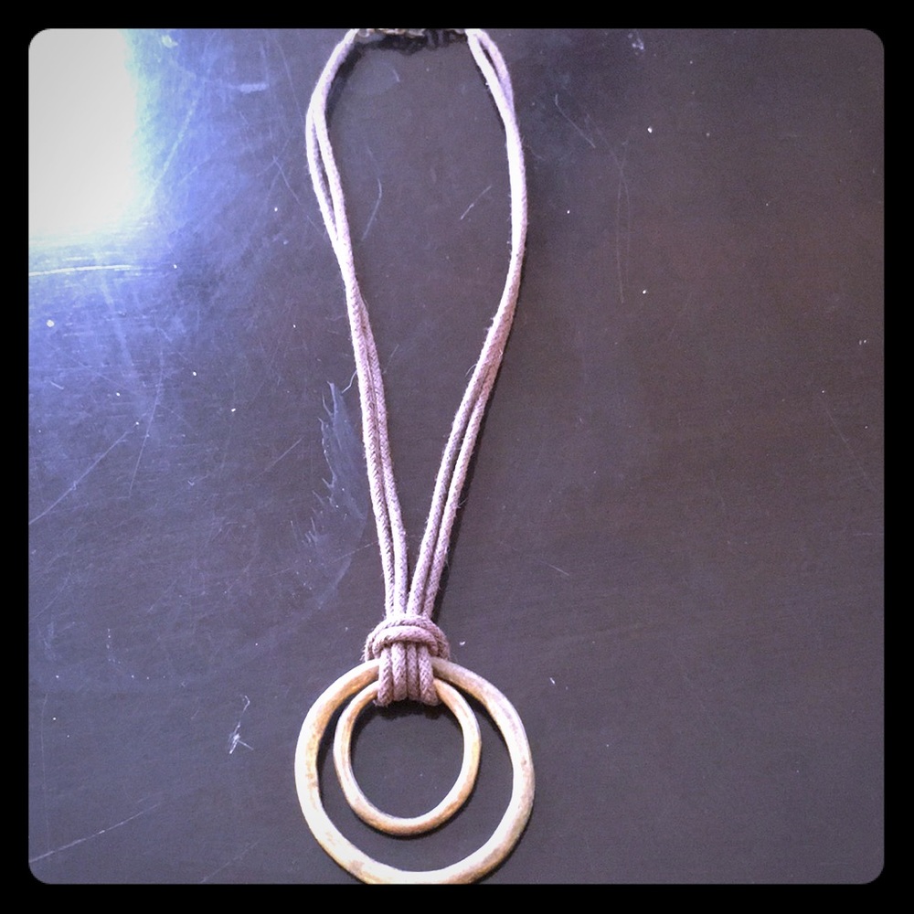 Circle necklace on brown fabric chain